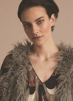 Load image into Gallery viewer, Front close up view of a woman wearing the summum faux fur gilet in clay.

