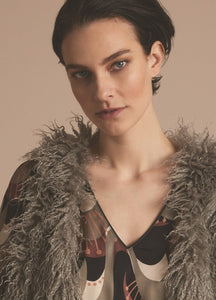 Front close up view of a woman wearing the summum faux fur gilet in clay.