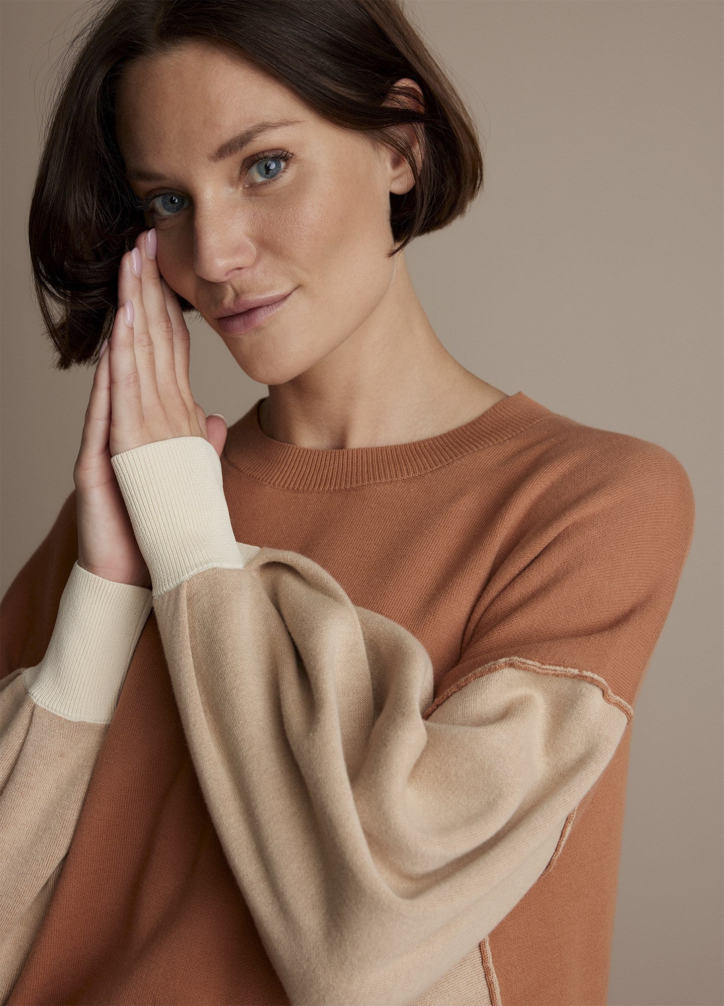 Front close up view of a woman wearing the summum double bed jumper with puff sleeves.
