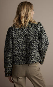 Back top half view of a woman wearing the summum lightly quilted jacket.