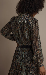Back top half view of a woman wearing the summum brown print top