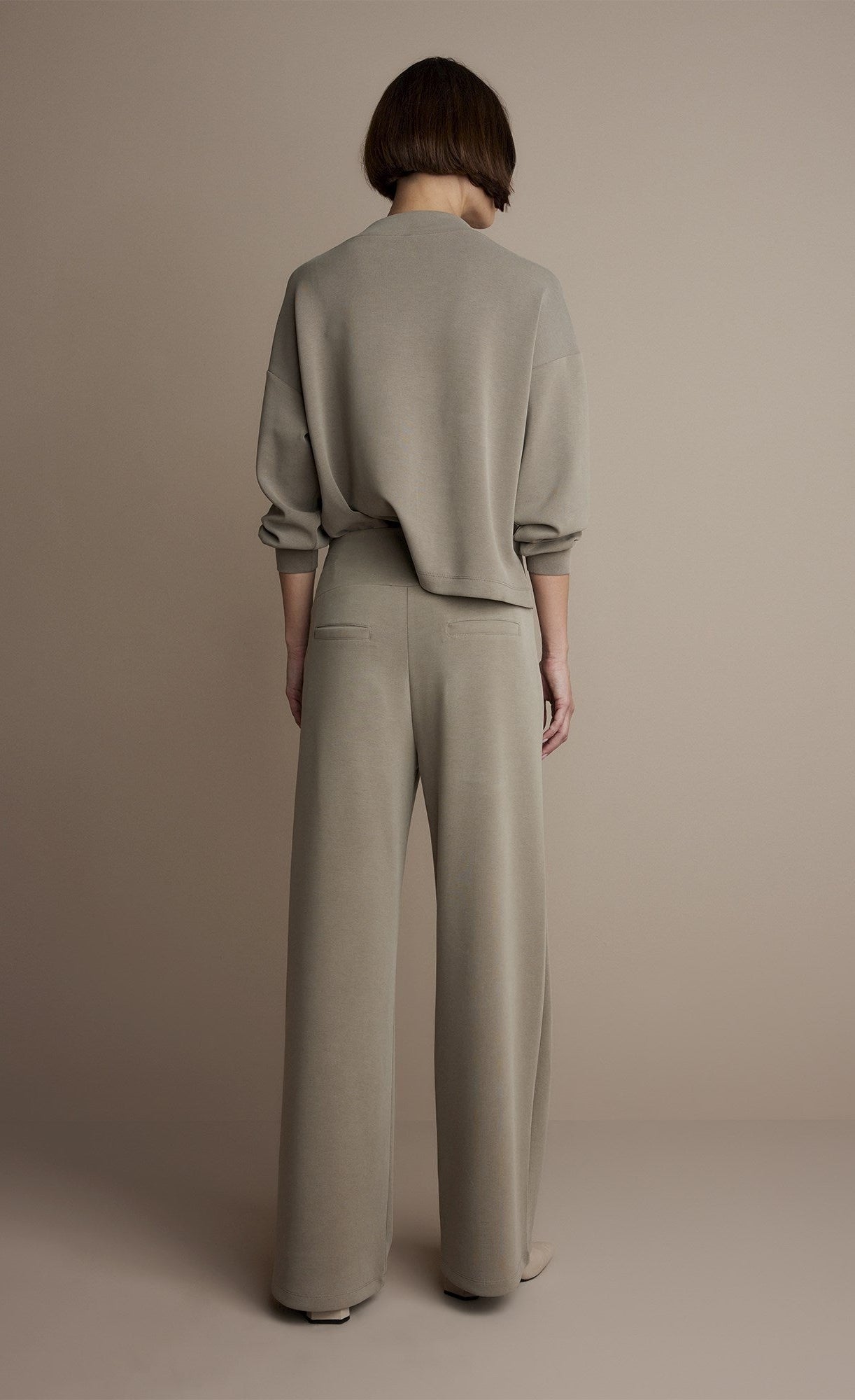 Back full body view of a woman wearing the Summum Clay Scuba Wide-Leg Sweatpant