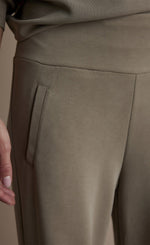 Load image into Gallery viewer, Front close up view of a woman wearing the Summum Clay Scuba Wide-Leg Sweatpant
