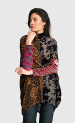Load image into Gallery viewer, A woman modeling a high-neck, long tunic top with mixed animal and floral prints. The top features leopard print on one side, a black floral print on the other, and bright pink and green floral sleeves.
