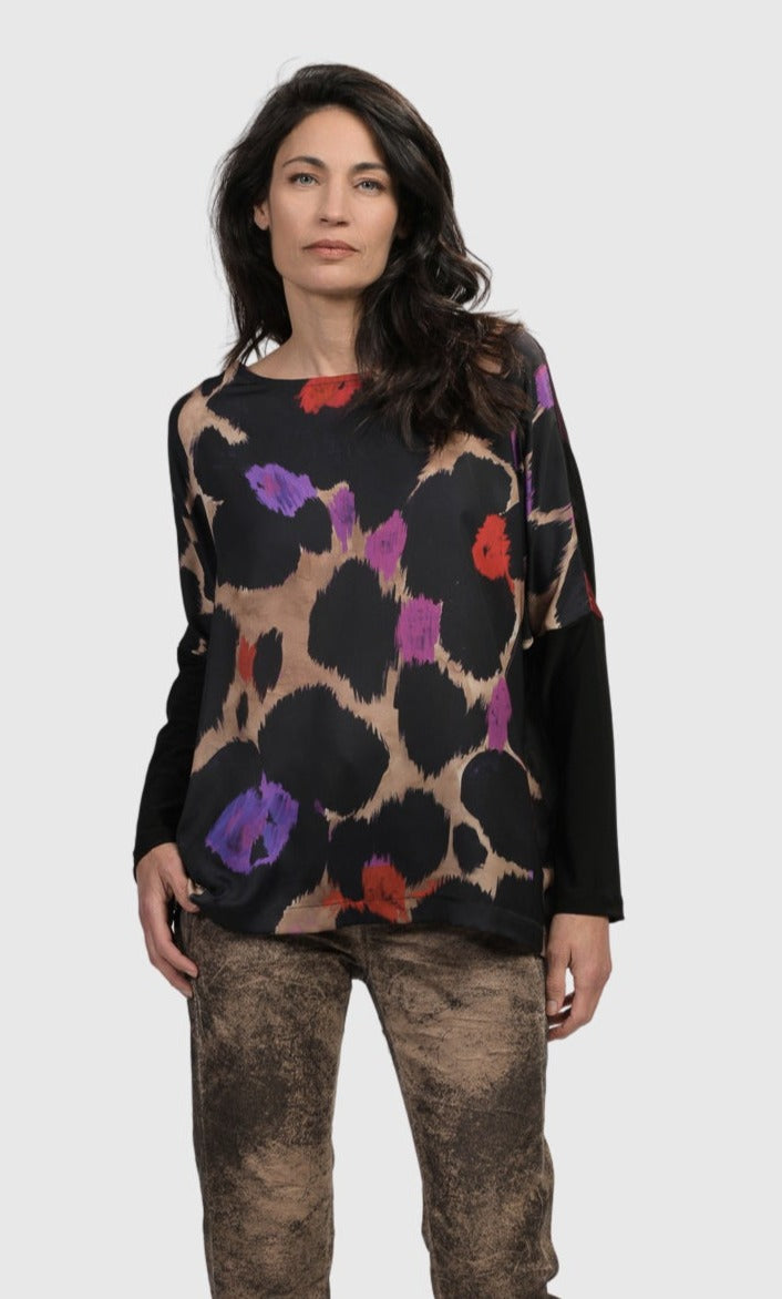 Front top half view of a woman wearing the Alembika Cosmopolitan Long Sleeve Violet Tee