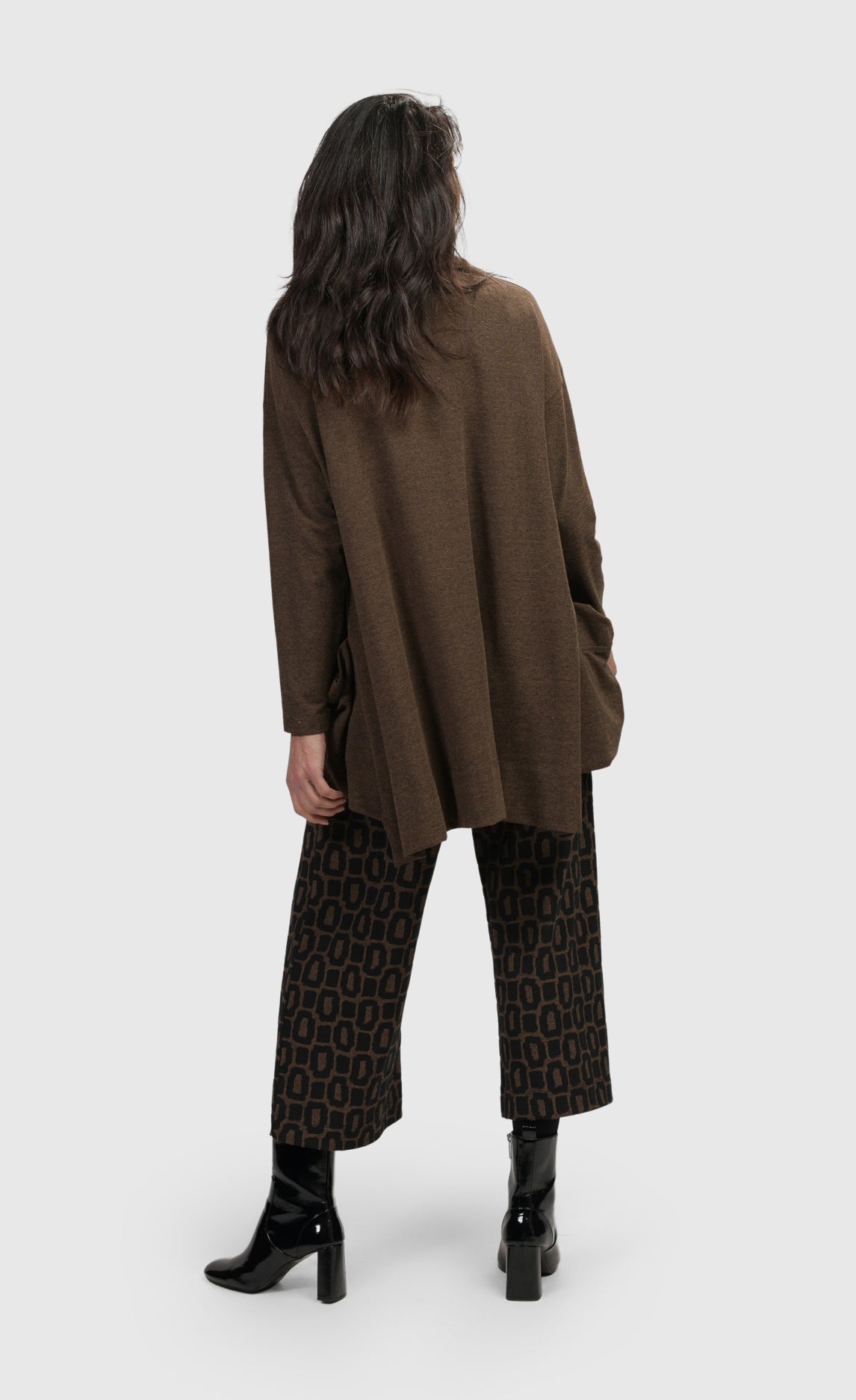 Back full body view of a woman wearing the Alembika Essential Trapeze Brown Top