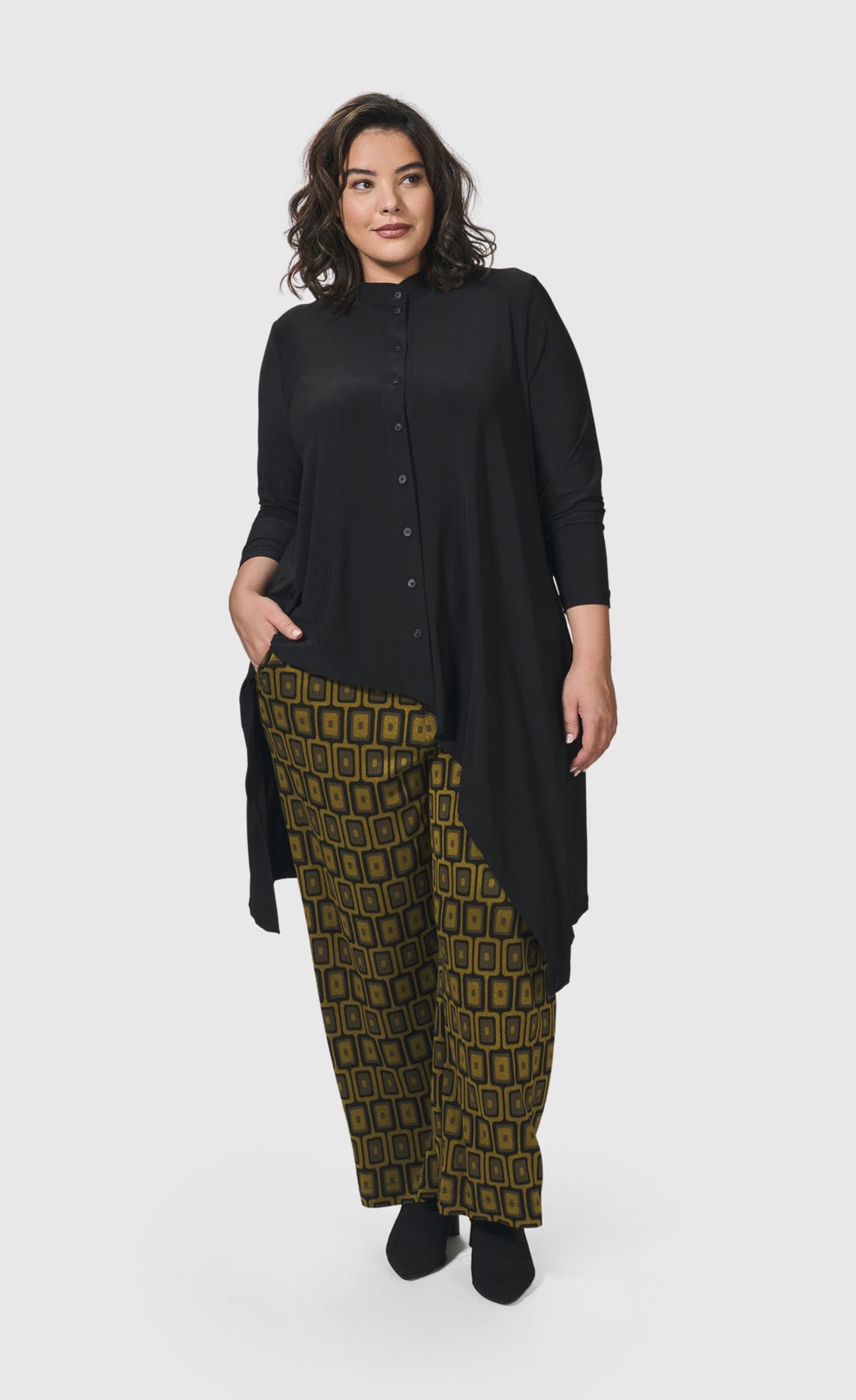 Front full body view of a woman wearing the Alembika Essential Hi-Lo Button Down Top