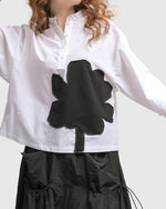 Load image into Gallery viewer, Front close up view of a woman wearing the Alembika Urban Modern Flower Top
