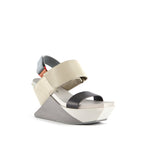 Load image into Gallery viewer, front outer side view of the united nude delta wedge sandals in neutral.
