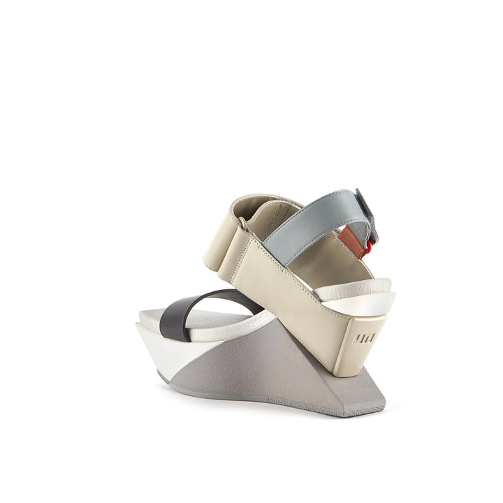 back inner side view of the united nude delta wedge sandals in neutral.