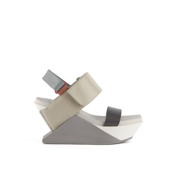 outer side view of the united nude delta wedge sandals in neutral.
