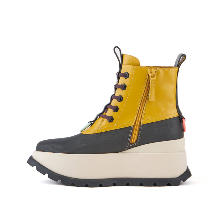 Inner side view of the united nude roko patrol boot in golden spice.