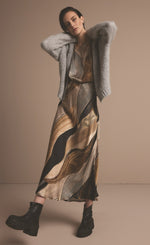 Load image into Gallery viewer, Front full body view of a woman wearing the Summum Flowy Lines Organic Print Long Skirt
