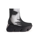Load image into Gallery viewer, A black platform ankle boot with a ribbed knit sock-like upper and a chunky black sole, shown in profile.
