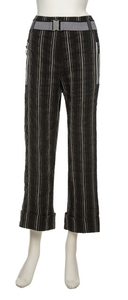 Front, bottom half view of a mannequin wearing the Beate Heymann Stripped Culotte Pant. These pants are black with white stripes. They have a straight leg with a cuffed bottom, two front zip pockets, and a black and white belt.