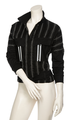 Load image into Gallery viewer, Front, top half view of a mannequin wearing the Beate Heymann Stripped Jacket. This jacket is black with white stripes. The sleeves are solid black and the front has two patch, solid black pockets with a single white stripe on them. The jacket has a zip up front and belt near the bottom.
