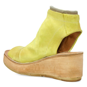 Inner side view of the AS98 naylor wedge sandal in the color zen/yellow. this sandal has a wood-like wedge and leather covering the foot and ankle. The sandal has an open toe and heel.