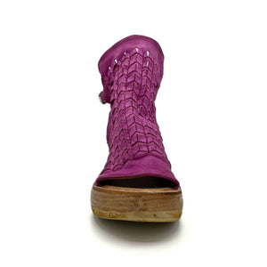 front view of the as98 newbury fuchsia wedge. This wedge has a woven leather front, open sides, an open toe, and leather on the back that connects to the front with a leather buckle strap