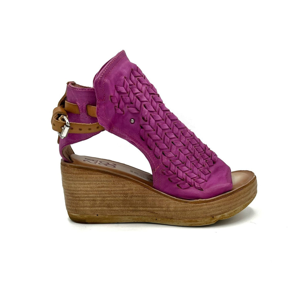 outer side view of the as98 newbury fuchsia wedge. This wedge has a woven leather front, open sides, an open toe, and leather on the back that connects to the front with a leather buckle strap