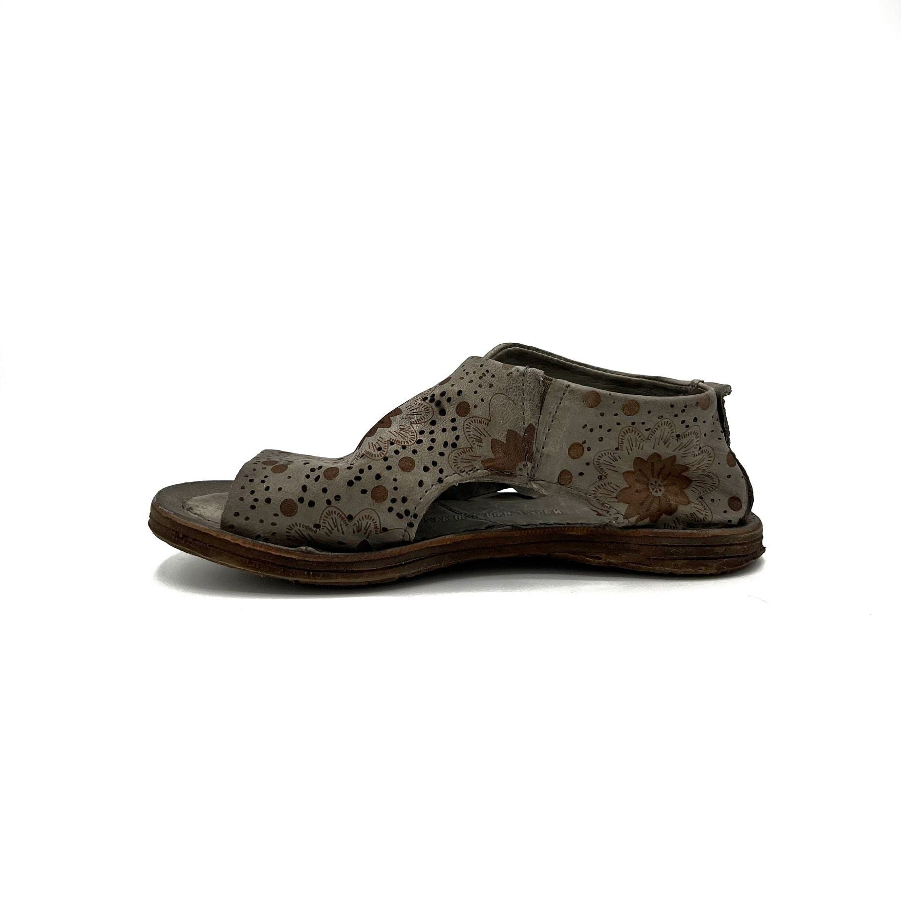 inner side view of the as98 ronald flat. This shoe is grey with an embossed, brown, floral pattern. the shoe has an open toe with the rest of the foot being covered by leather.