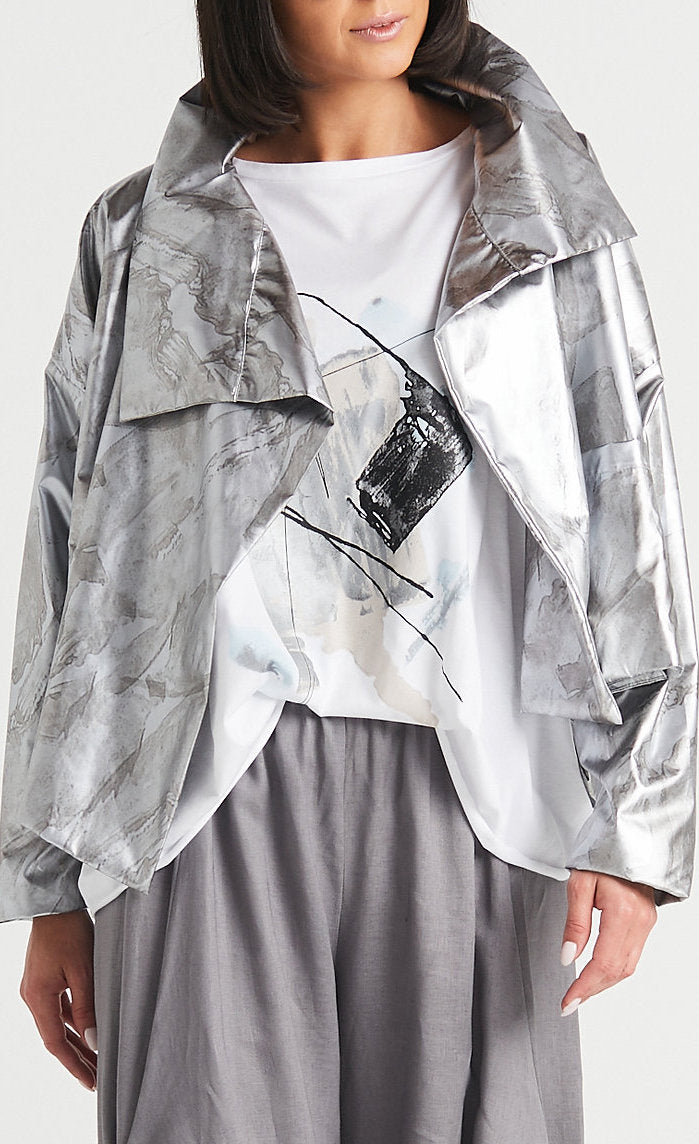 Front view of a woman wearing the Planet cropped asymmetrical jacket in marble.