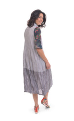 Load image into Gallery viewer, Back full body view of a woman wearing the alembika flora dress. This dress has navy and white striping, a button down front, and floral 3/4 sleeves. The bottom 1/4 of the dress is more transparent than the top 3/4.
