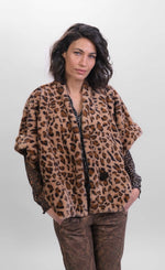 Load image into Gallery viewer, Front top half view of a woman wearing the Alembika kenya kimono in a brown cheetah print. This kimono has a single front button, short sleeves, and a fuzzy appearance.
