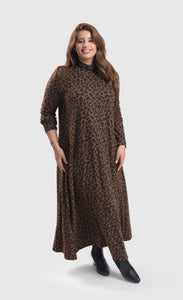 Front full body view of a woman wearing the alembika chiu swing dress. This dress is brown with black cheetah print. It has long sleeves and a turtleneck.