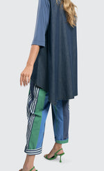 Load image into Gallery viewer, Back bottom half view of a woman wearing the alembika denim top.
