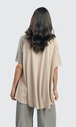 Load image into Gallery viewer, Back top half view of a woman wearing the alembika essential colorblock cupro trapeze top
