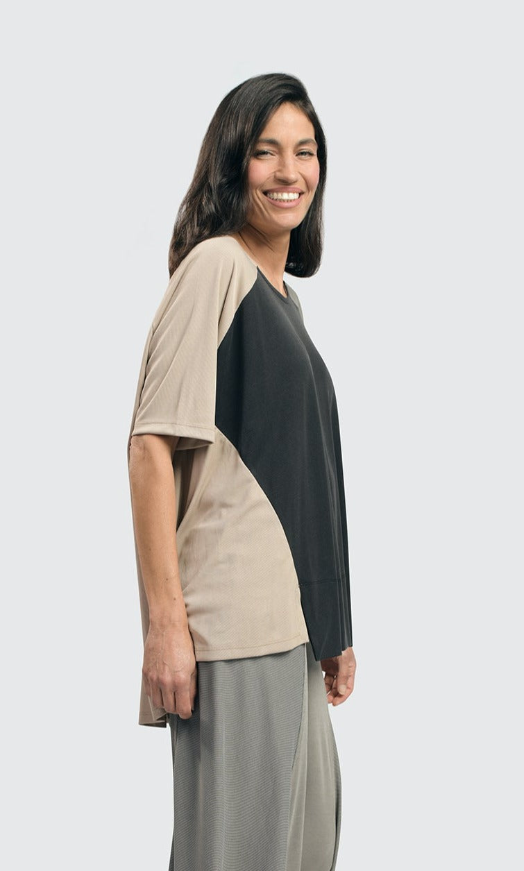 left side top half view of a woman wearing the alembika essential colorblock cupro trapeze top