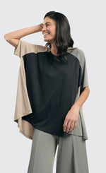 Load image into Gallery viewer, Front top half view of a woman wearing the alembika essential colorblock cupro trapeze top
