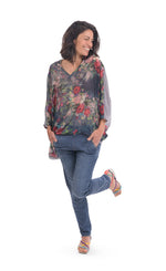 Load image into Gallery viewer, Front full body view of a woman wearing jeans and the alembika flora top. This top has a floral print on the front, an oversized fit, a v-neck, and 3/4 length sleeves.

