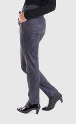 Load image into Gallery viewer, Left side bottom half view of a woman wearing the alembika iconic stretch jeans in indigo. These pull-on jeans have a drawstring waistband, a straight leg, two back pockets, and front slant pockets.

