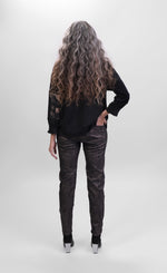 Load image into Gallery viewer, Back full body view of a woman wearing the alembika bronze top and the alembika iconic stretch pant in the color sepia. The pant is dark brown/black with a small metallic-like animal print.

