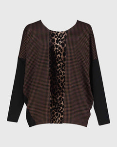 Front view of the alembika leopard panel top. This top has a round neck, solid black drop shoulder dolman sleeves, a brown body, and a leopard print panel running down the center of the front.