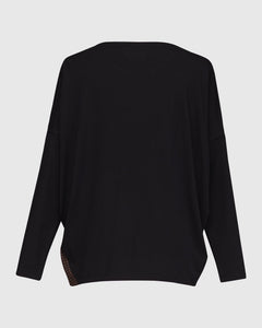 Back view of the alembika leopard panel top. This top has solid black drop shoulder dolman sleeves and a solid black back.