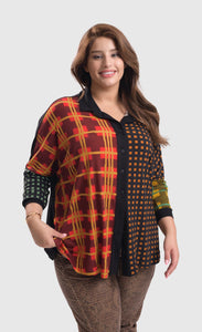 Front top half view of a woman wearing brown pants and the alembika multi check blouse. This blouse has a mix of plaid and checkered prints on the front, a button up front, and dolman long sleeves..