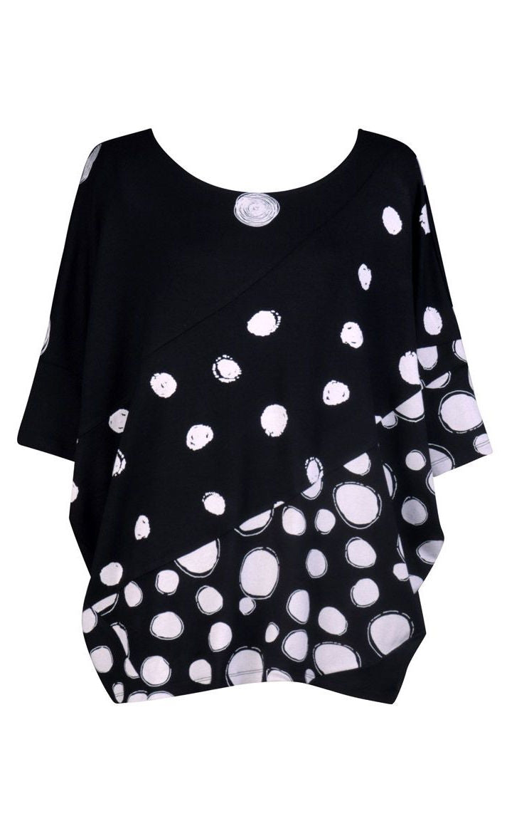 Front view of the alembika multi spotted lia jersey top. This top is black with different types of white spots all over it. The sleeves are 3/4 length and the shirt has an oversized fit.
