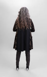 Load image into Gallery viewer, Back full body view of a woman wearing the alembika nala velvet jacket in leopard print. The jacket sits below the hips. The back of the jacket is solid back.
