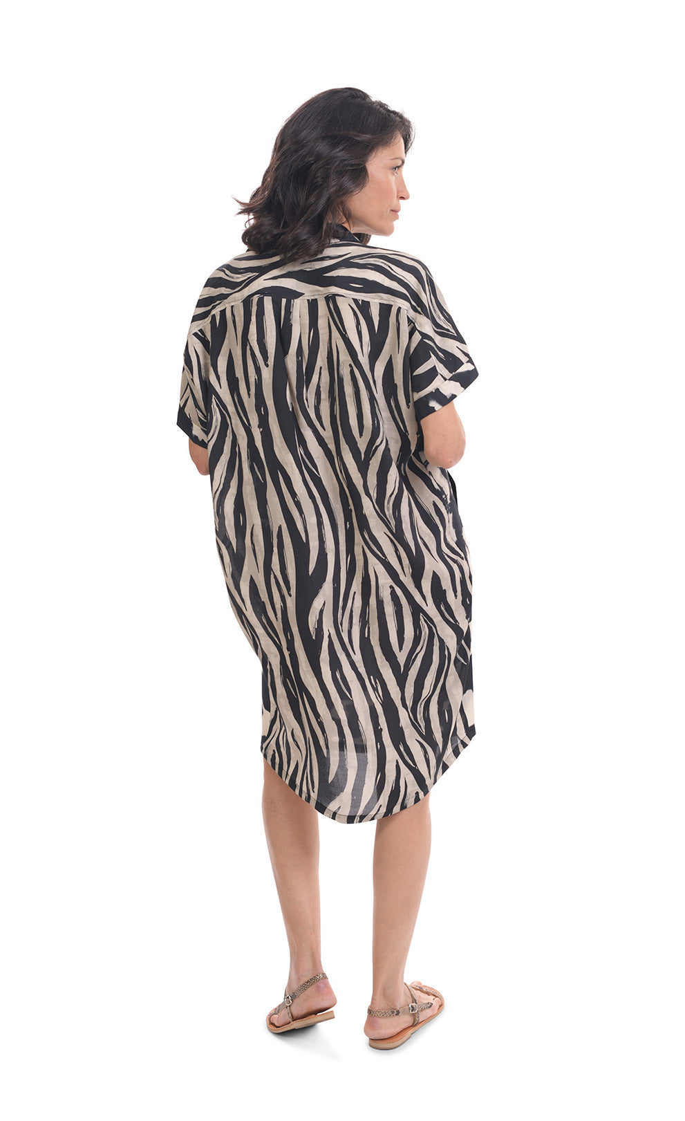 Back full body view of a woman wearing the alembika Speckled Shayna Shirtdress. This shirtdress has short sleeves and black and white wavy striped print on the back