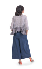 Load image into Gallery viewer, Back full body view of a woman wearing wide jeans and the alembika gingham Rhys Ruffled Blouse. This top has a blue and white plaid print, cold shoulder 3/4 length sleeves, and a ruffled hem.
