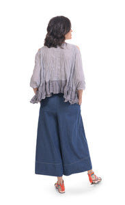 Back full body view of a woman wearing wide jeans and the alembika gingham Rhys Ruffled Blouse. This top has a blue and white plaid print, cold shoulder 3/4 length sleeves, and a ruffled hem.