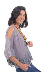 Load image into Gallery viewer, Right side top half view of a woman wearing wide jeans and the alembika gingham Rhys Ruffled Blouse. This top has a blue and white plaid print, cold shoulder 3/4 length sleeves, and a ruffled hem.
