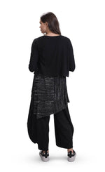 Load image into Gallery viewer, Back full body view of the alembika essential rib cardigan. This cardi has 3/4 length sleeves and a slightly cropped hem. The model is wearing it over a black and white long top and black pants.
