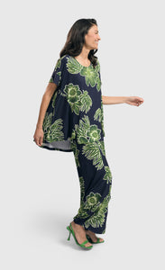 Front full body view of a woman wearing the alembika royal/green hula hi-lo swing top