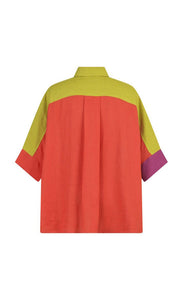 Back view of the alembika colorblock linen shirt. This shirt is red on the back, purple on the right side and yellow on shoulder and sleeve sides. The shirt has elbow length sleeves. 