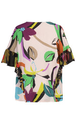 Load image into Gallery viewer, Back view of the Alembika Floral Vneck tee. This tee has a dark tropical jungle print on sleeves and sides with a light tropical jungle print showing on the back. The top also has elbow length sleeves with ruffles that run down the side of the top.
