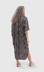 Load image into Gallery viewer, Back full body view of a woman wearing the alembika skye caftan butterfly dress. This dress is long and has black and white striping on the back.
