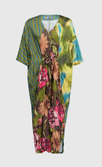 Load image into Gallery viewer, Front full view of a the alembika skye caftan dress in the color aquamarine. This dress has green, yellow, and blue tie dye on the left side, blue and green stripes on the right side and back, and pink flowers on a brown backdrop down the center of the front. The center of the front of the dress is tied to bring the waist in.
